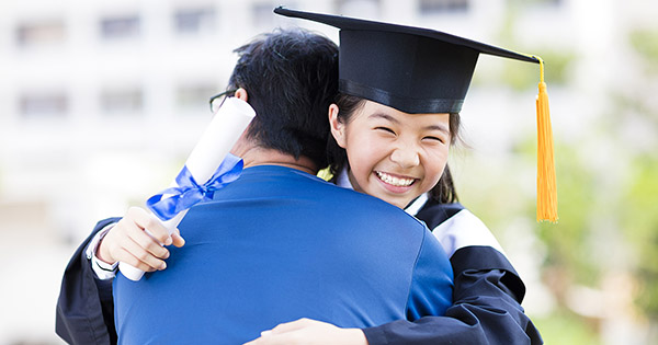 Blog: Student Satisfaction and Academic Experiences, female college graduate hugging parent