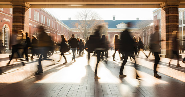 Blog on Strategic Planning: Image of a campus quad with blurred images of students walking